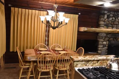 a dining room with a table and chairs at 52 Tuolumne Meadow in Wawona