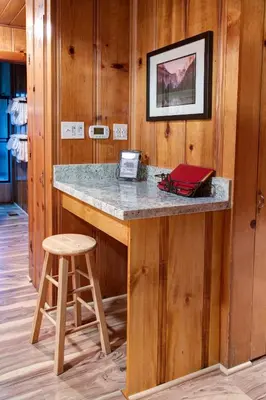 a kitchen with a counter and a bar stool at 74 Our Yosemite Getaway in Wawona