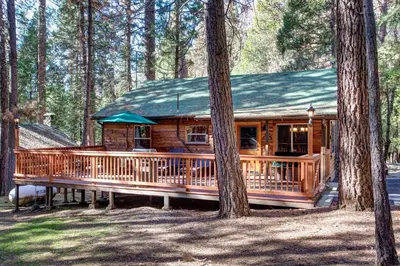 a wooden cabin in the woods with trees at 74 Our Yosemite Getaway in Wawona