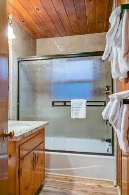 a bathroom with a shower with a glass door at 74 Our Yosemite Getaway in Wawona
