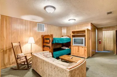 a living room with a couch and a bunk bed at 64 River Lodge in North Wawona