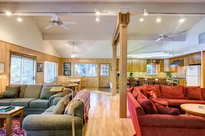 a living room with two couches and a kitchen at 64 River Lodge in North Wawona