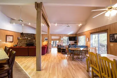 a dining room and living room with a table and chairs at 64 River Lodge in North Wawona