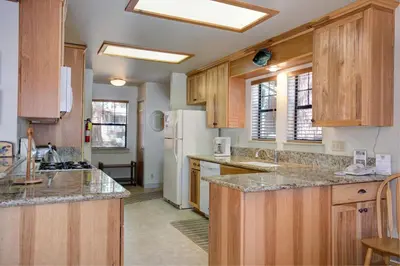 a kitchen with wooden cabinets and a white refrigerator at 1A Wawona Retreat in Wawona