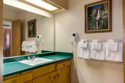 a bathroom with a sink and a mirror at 1A Wawona Retreat in Wawona