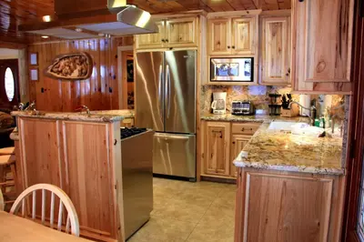 a kitchen with wooden cabinets and a stainless steel refrigerator at 66 Grizzly Giant in Wawona