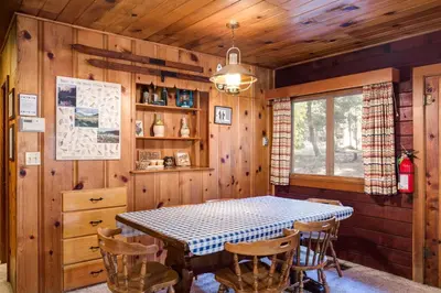 a dining room with a table and chairs at 53 Creekside Cabin in Wawona