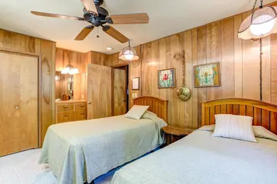 a bedroom with two beds and a ceiling fan at 4B Mountain Memory in Wawona