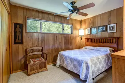 a bedroom with a bed and a ceiling fan at 4B Mountain Memory in Wawona
