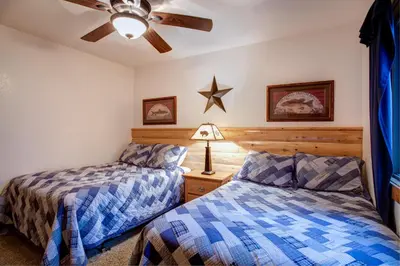 a bedroom with two beds and a ceiling fan at 2N Big Pine Lodge in Wawona