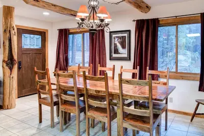 a dining room with a wooden table and chairs at 2N Big Pine Lodge in Wawona