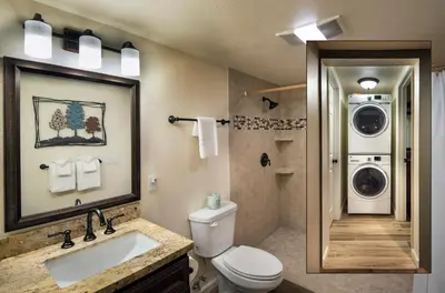 a bathroom with a toilet and a washing machine at 20B We-Dunn-It in Wawona