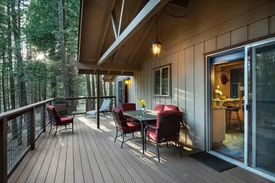 a wooden deck with a table and chairs on it at 20B We-Dunn-It in Wawona