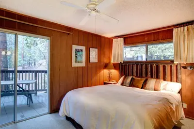 a bedroom with a bed and a balcony at 12B Star Gazers in Wawona