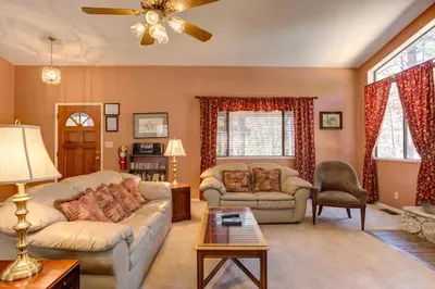 a living room with a couch and a table at 1 Cabin Among the Firs in Wawona