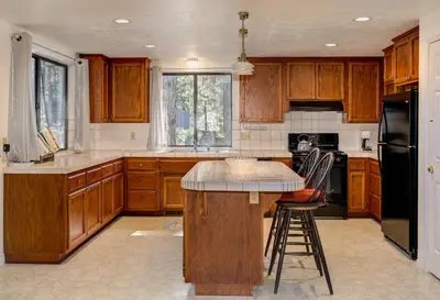 a kitchen with wooden cabinets and a counter top at 1 Cabin Among the Firs in Wawona