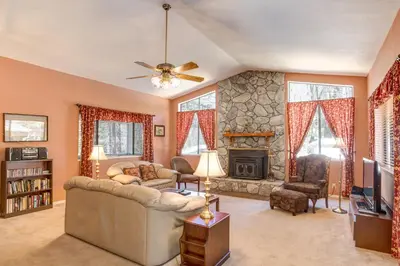 a living room with a couch and a fireplace at 1 Cabin Among the Firs in Wawona