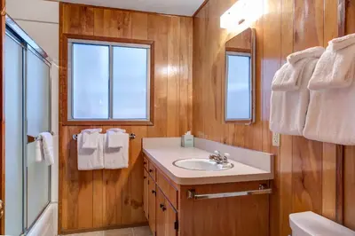 a bathroom with a sink and a shower and a mirror at 3A Cutters Edge in Wawona