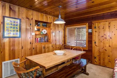 a wooden dining room with a wooden table and chairs at 70 Simmons Den in Wawona