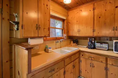 a kitchen with wooden cabinets and a sink at 73 Walk-A-Bout in Wawona