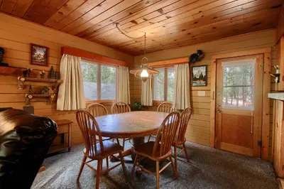 a dining room with a wooden table and chairs at 73 Walk-A-Bout in Wawona