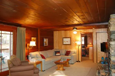 a living room with a couch and a table at 6 Squirrels Nest in Wawona
