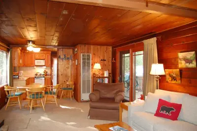 a living room with a couch and a table at 6 Squirrels Nest in Wawona