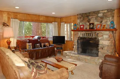 a living room with a couch and a fireplace at 23 Arnetts Cabin in North Wawona