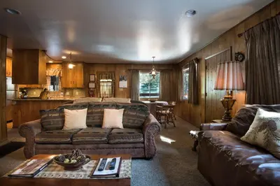 a living room with a couch and a table at 23 Arnetts Cabin in North Wawona