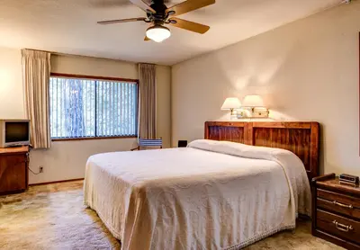 a bedroom with a bed and a ceiling fan at 40 Coyles Cabin in Wawona
