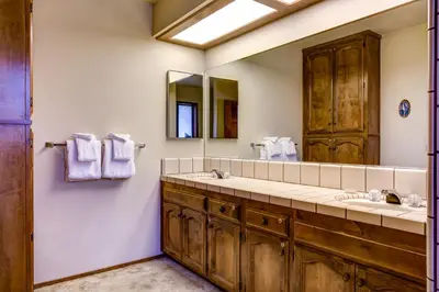 a bathroom with two sinks and a large mirror at 40 Coyles Cabin in Wawona