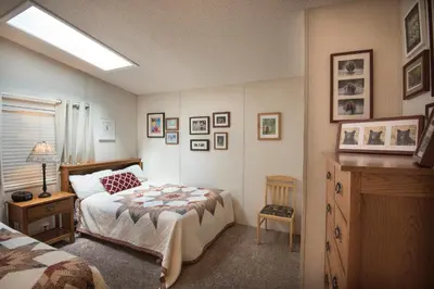 a bedroom with a bed and a dresser in it at 42R Rosenberg's Creekside Cabin in Wawona