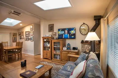 a living room with a couch and a table at 42R Rosenberg's Creekside Cabin in Wawona