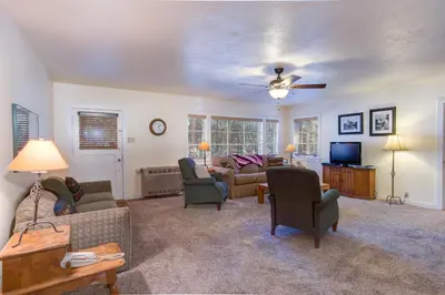 a living room with couches and chairs and a ceiling fan at 81 Ashbaugh Meadow in North Wawona