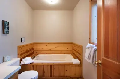 a bathroom with a bath tub and a toilet at 24 Wawona Cabin in Wawona