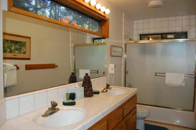 a bathroom with two sinks and a shower at 18A Pohono Pines in Wawona