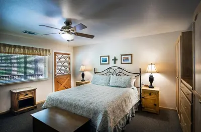 a bedroom with a bed and a ceiling fan at 2A The Terry Cabin in North Wawona