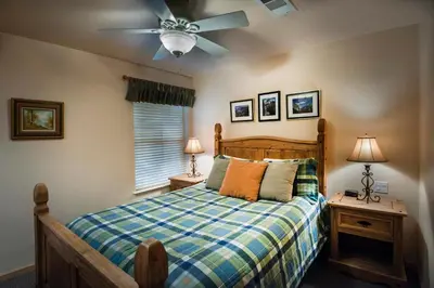 a bedroom with a bed and a ceiling fan at 2A The Terry Cabin in North Wawona