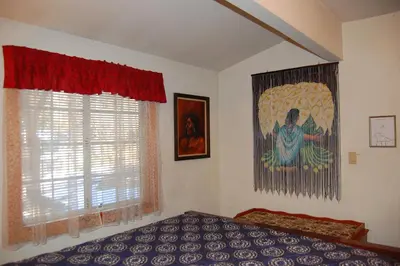 a bedroom with a bed and a painting on the wall at 10N Black Oak Lodge in Wawona