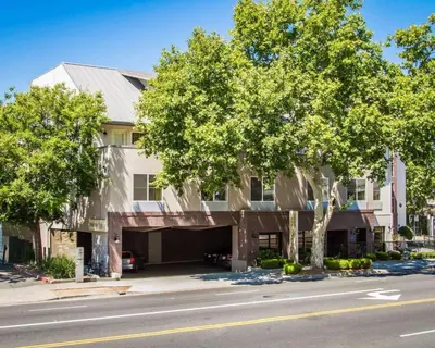 an apartment building with a garage on a street at Hotel Med Park, an Ascend Collection Hotel in Sacramento