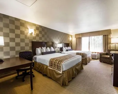 a hotel room with two beds and a desk at Hotel Med Park, an Ascend Collection Hotel in Sacramento