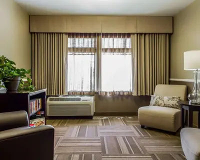 a living room with a couch and a chair and a window at Hotel Med Park, an Ascend Collection Hotel in Sacramento