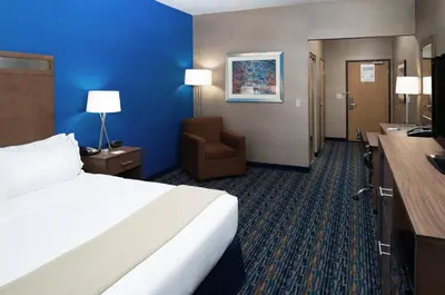 a hotel room with a bed and a chair at Holiday Inn Express Rocklin - Galleria Area by IHG in Rocklin