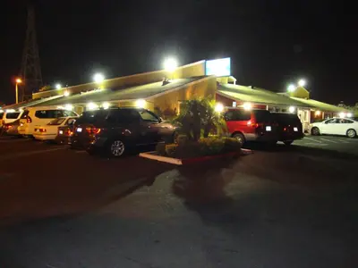 a parking lot with cars parked in front of a store at Oasis Inn Sacramento- Elk Grove in Sacramento