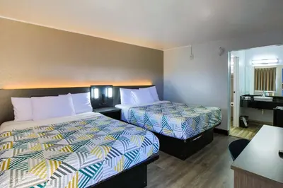 a hotel room with two beds and a sink at Motel 6-Sacramento, CA - North in Sacramento