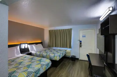 a hotel room with two beds and a desk at Motel 6-Sacramento, CA - North in Sacramento