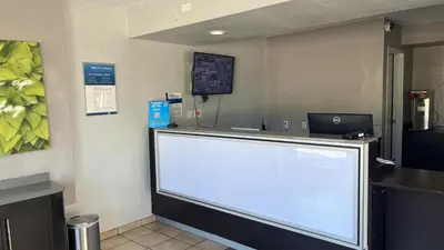 a large white sign in a waiting room at Motel 6 Modesto, CA in Modesto