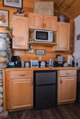 a kitchen with wooden cabinets and a microwave at Fireside Lodge in South Lake Tahoe