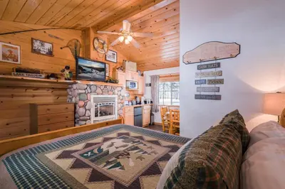 a living room with a couch and a fireplace at Fireside Lodge in South Lake Tahoe