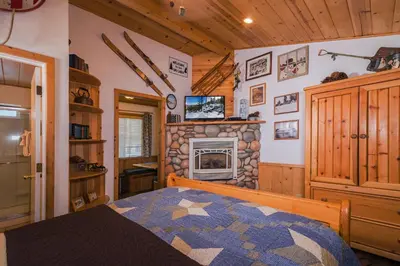 a bedroom with a fireplace and a bed in a room at Fireside Lodge in South Lake Tahoe